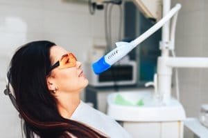 A woman receives teeth whitening treatment in Pearland TX