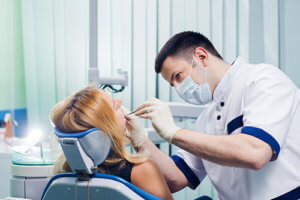 an orthodontist examines a patient to determine the need for orthognathic surgery