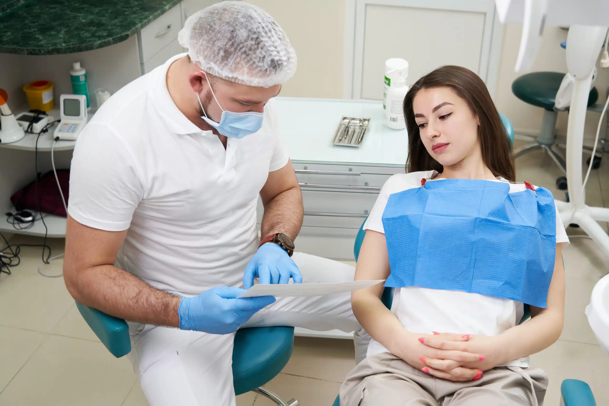 Doctor shows the patient an x-ray image. Computer diagnostics. dental tomography Orthodontic Care in Houston for All Ages