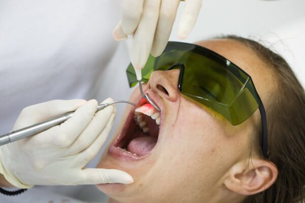 Laser dentistry procedure being performed on an orthodontic patient wearing